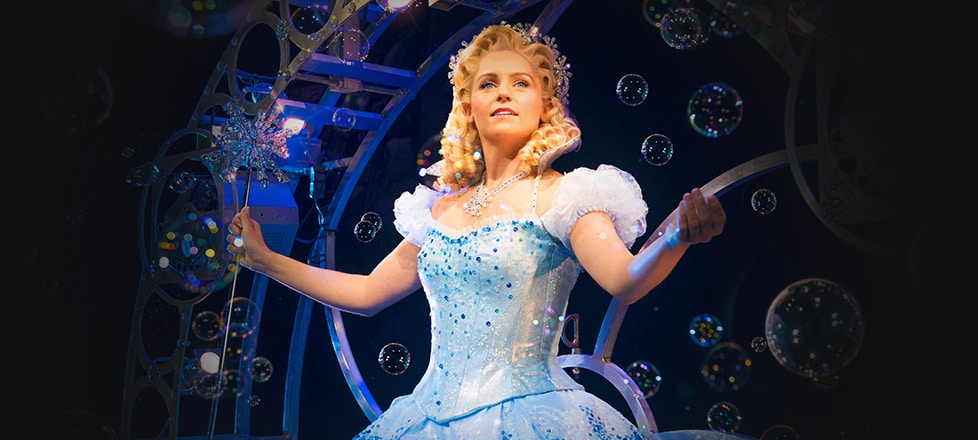 Glinda descending in her bubble with dozens of other bubbles floating around her