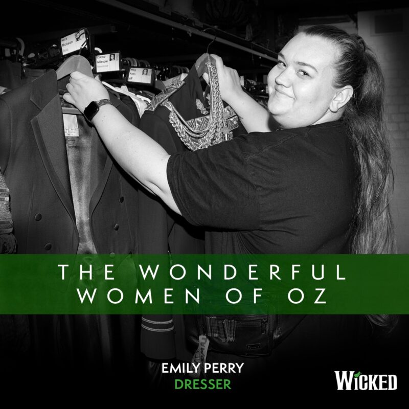 An image of Emily Perry, Dresser hanging costumes. We see the text "The Wonderful Women of Oz"