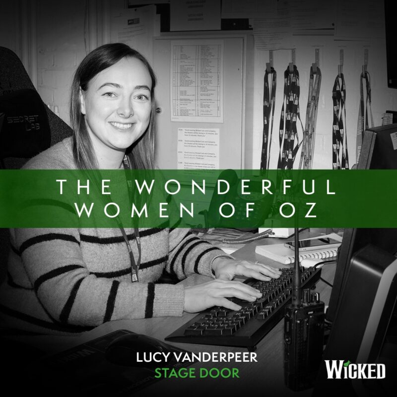 An image of Lucy Vanderpeer, Stage Door, sitting just inside the stage door. We see the text "The Wonderful Women of Oz"