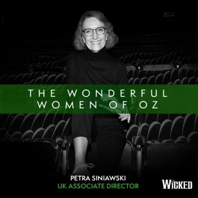 An image of Petra Siniawski, UK Associate Director, sitting in the house of the theater. We see the text "The Wonderful Women of Oz"