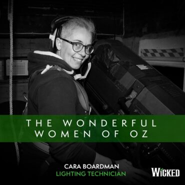 An image of Cara Boardman, Lighting Technician, sitting in the tech booth with a headset on. We see the text "The Wonderful Women of Oz"