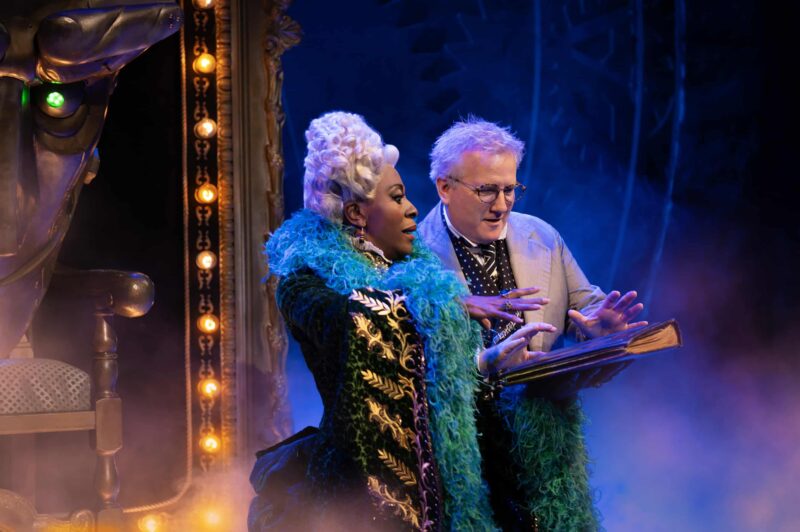 The Wizard and Madame Morrible looking at spell book
