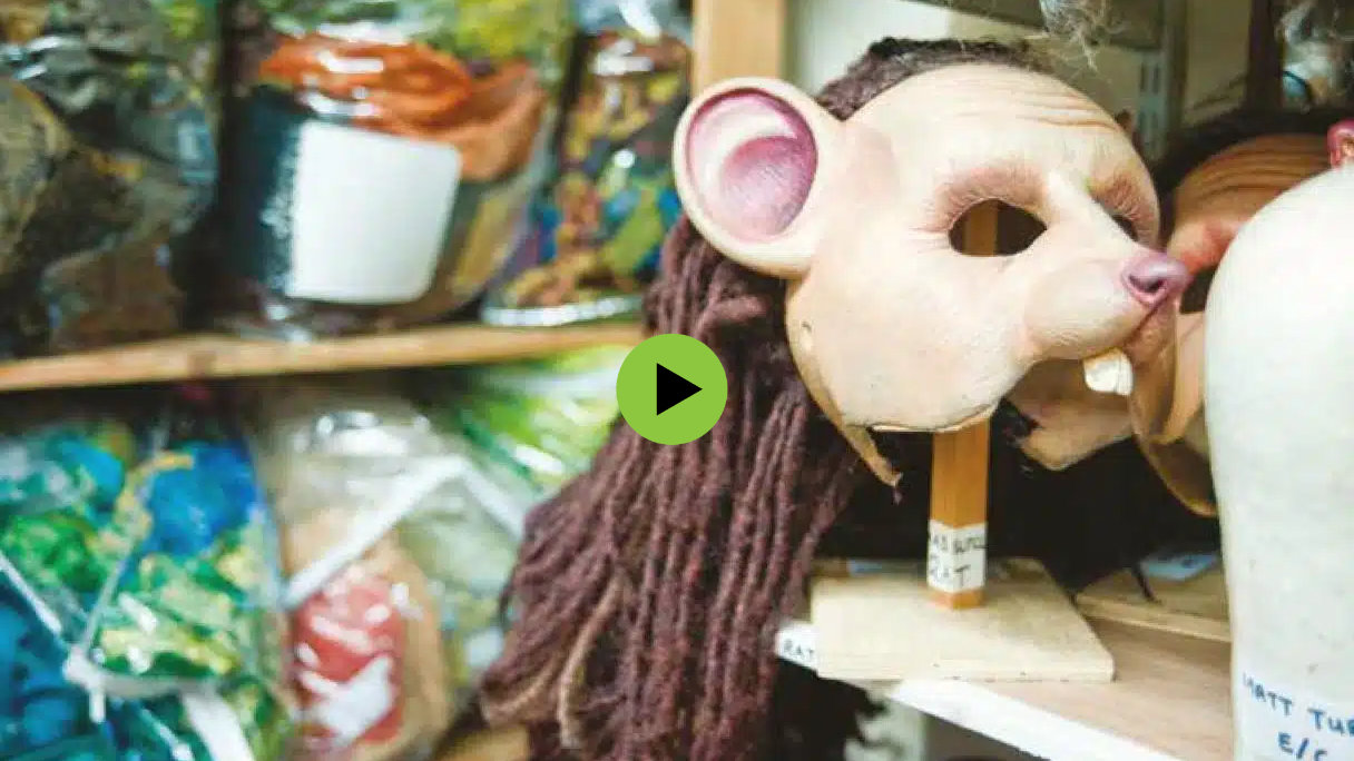 Video still of backstage at Wicked with different costumes from the show.